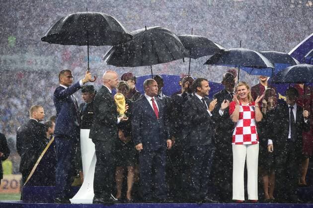 President of Russia Vladimir Putin (C) shelters from the rain alongside FIFA President Gianni Infantino (L) following the 2018 FIFA World Cup WM Weltmeisterschaft Fussball final match at Luzhniki Stadium in Moscow, Russia on July 15, 2018. France beat Croatia 4-2.  MOS20180715115 CHRISxBRUNSKILL