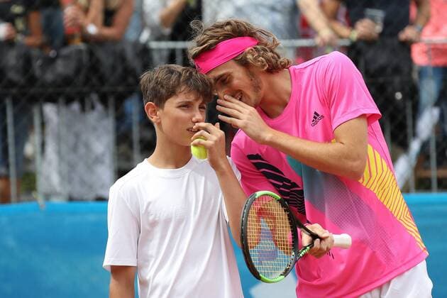 TENNIS - Club Challenge, Thiem vs Tsitsipas WOERSCHACH,AUSTRIA,16.JUL.18 - TENNIS - Adidas Club Challenge, Dominic Thiem vs Stefano Tsitsipas. Image shows Stefanos Tsitsipas (GRE) with a child. GEPAxpictures xChristianxWalgram