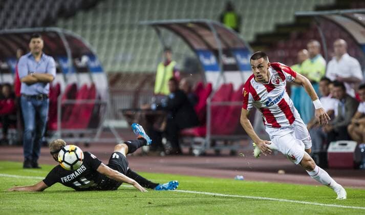 17th July 2018, Rajko Mitic Stadium, Belgrade, Serbia; UEFA Champions League Qualification, first qualifying round, 2nd leg, Red Star Belgrade versus Spartaks Jurmala; Defender Milan Rodic of Red Star Belgrade skips past the challenge fromt Defender Gints Freimanis of Spartak Jurmala  ActionPlus12048454 NikolaxKrstic