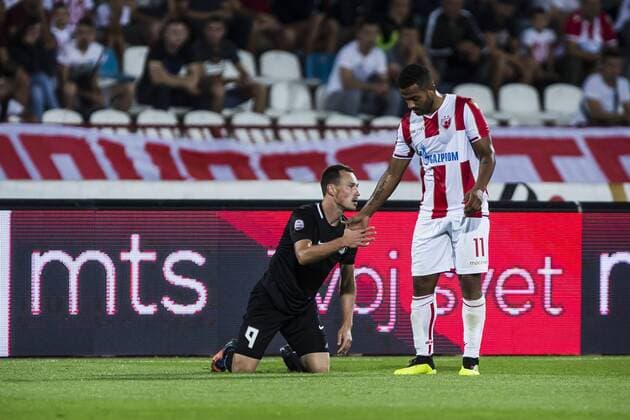 17th July 2018, Rajko Mitic Stadium, Belgrade, Serbia; UEFA Champions League Qualification, first qualifying round, 2nd leg, Red Star Belgrade versus Spartaks Jurmala; Midfielder Lorenzo Ebecilio of Red Star Belgrade helps Midfielder Aleksejs Visnakovs of Spartak Jurmala to stand up after the foul  ActionPlus12048444 NikolaxKrstic