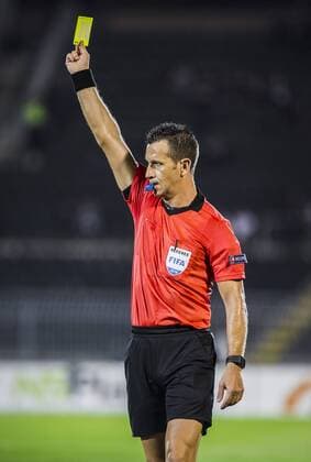 19th July 2018, Partizan Stadium, Belgrade, Serbia; UEFA Europa League football, first qualifying round, 2nd leg, Partizan versus Rudar Pljevlja; Referee Daniele Doveri of Itay gives a yellow card to Milija Golubovic of Rudar Pljevlja  ActionPlus12048885 NikolaxKrstic