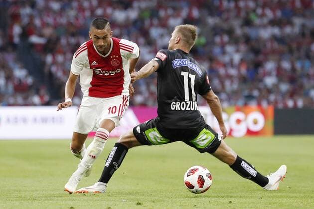 (L-R) Hakim Ziyech of Ajax, Lukas Grozurek of Sturm Graz during the UEFA Champions League second round qualifying first leg match between Ajax Amsterdam and Sturm Graz at the Johan Cruijff Arena on July 25, 2018 in Amsterdam, The Netherlands UEFA Champions League 2018 2019 xVIxVIxImagesx xMauricexvanxSteenxIVx 11586503