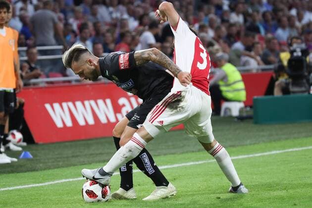 SOCCER - UEFA CL quali, Ajax vs Sturm AMSTERDAM,NETHERLANDS,25.JUL.18 - SOCCER - UEFA Champions League qualification, AFC Ajax Amsterdam vs SK Sturm Graz. Image shows Peter Zulj (Sturm) and Nico Tagliafico (Ajax). GEPAxpictures xChristianxWalgram