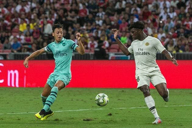 July 28, 2018 - Singapore - Mesut Ozil of Arsenal and LoÃ¯c Mbe Soh of Paris St Germain in action during the International Champions Cup match between Arsenal and Paris Saint Germain at the National Stadium. Soccer 2018: Champions Cup: Arsenal 4:1 Paris St Germain  - ZUMA 20180728_mda_h321_015 Copyright: xDanialxHakimx