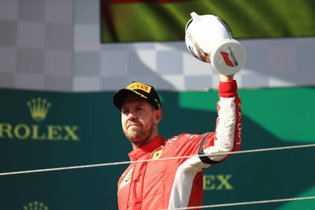 29th July 2018, Hungaroring, Mogyorod, Hungary; Hungarian Formula One Grand Prix, race day; Scuderia Ferrari, Sebastian Vettel accepts his trophy on the podium as he comes home in second place  ActionPlus12051627 Octane