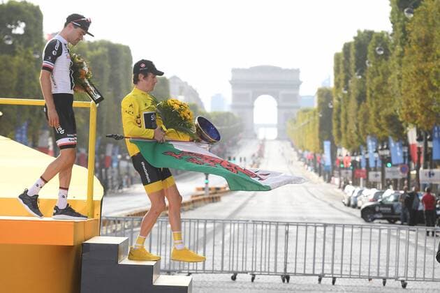 Dutch Tom Dumoulin of Team Sunweb and British Geraint Thomas of Team Sky wearing the yellow jersey of overall leader, carrying a Welsh flag, leave the podiumn with a view on the Arc de Triomphe, on the Champs Elysees, after the last stage of the 105th edition of the Tour de France cycling race, 116km from Houilles to Paris, France, Sunday 29 July 2018. This year s Tour de France takes place from July 7th to July 29th. DAVIDxSTOCKMAN  x05395073x