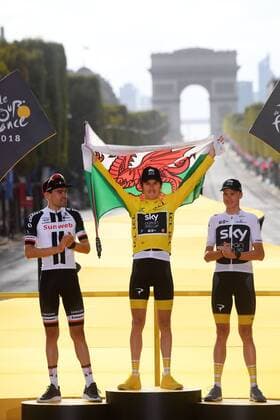 Dutch Tom Dumoulin of Team Sunweb, British Geraint Thomas of Team Sky wearing the yellow jersey of overall leader, with a Welsh flag over his shoulders and British Chris Froome of Team Sky celebrate on the podium after the last stage of the 105th edition of the Tour de France cycling race, 116km from Houilles to Paris, France, Sunday 29 July 2018. This year s Tour de France takes place from July 7th to July 29th. POOLxSTEPHANExMANTEY  x05395136x