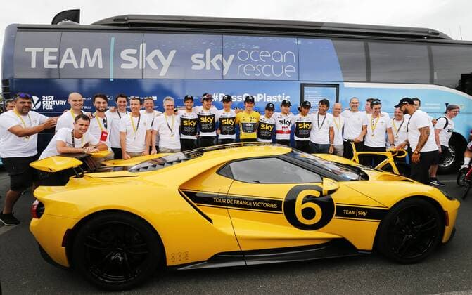 The riders and mechanics and team staff of Team Sky pose with a yellow personalized Ford GT sports car, after the last stage of the 105th edition of the Tour de France cycling race, 116km from Houilles to Paris, France, Sunday 29 July 2018. This year s Tour de France takes place from July 7th to July 29th. POOLxYUZURUxSUNADA  x05395151x
