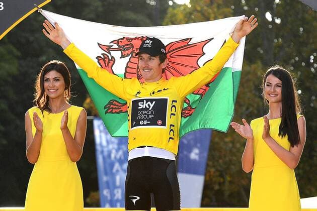 British Geraint Thomas of Team Sky wearing the yellow jersey of overall leader and holding a Welsh flag celebrates on the podium after the last stage of the 105th edition of the Tour de France cycling race, 116km from Houilles to Paris, France, Sunday 29 July 2018. This year s Tour de France takes place from July 7th to July 29th. DAVIDxSTOCKMAN  x05395190x