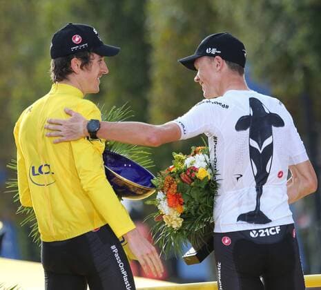 Geraint Thomas (L) and teammate Chris Froome of Great Britain celebrate on the presentation podium after Thomas won the Tour de France in Paris on July 29, 2018. Thomas claimed his first Tour de France victory, becoming the first Welshman to win the event.  PAR20180729012 DAVIDxSILPA