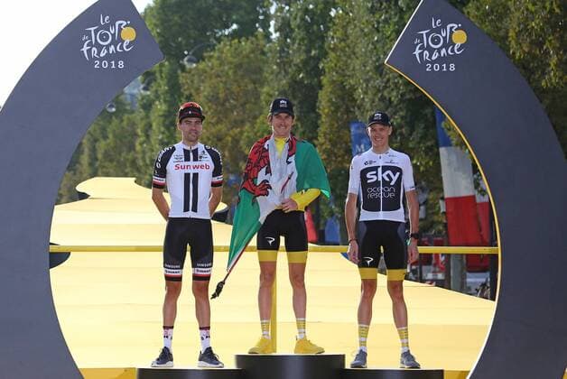 Tom Dumoulin of The Netherlands (L), Geraint Thomas of Great Britain (C) and Chris Froome of Great Britain arrive on the presentation podium after the conclusion of the Tour de France in Paris on July 29, 2018. Thomas claimed his first Tour de France victory, becoming the first Welshman to win the event.  PAR20180729033 DAVIDxSILPA