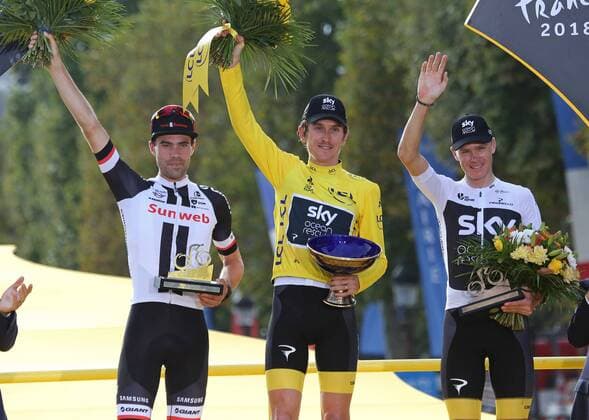 Tom Dumoulin of The Netherlands (L), Geraint Thomas of Great Britain (C) and Chris Froome of Great Britain arrive on the presentation podium after the conclusion of the Tour de France in Paris on July 29, 2018. Thomas claimed his first Tour de France victory, becoming the first Welshman to win the event.  PAR20180729037 DAVIDxSILPA
