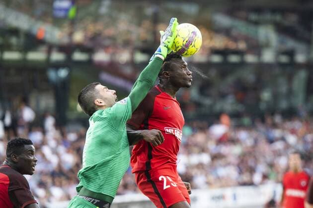 Fußball, CL Qualifikation, FC Midtjylland - FK Astana Bubacarr Sanneh ( 25 - FC Midtjylland ) in action with goalkeeper Nenad Eric ( 1 - FC Astana ) during UEFA Champions League, Second Qualifying Round between FC Midtjylland and FC Astana, August 1, 2018 in ARENA Herning, Denmark. Photo: Bo Amstrup Ritzau Scanpix , Herning Denmark  Copyright: BoxAmstrup BoxAmstrupx cop103 spdk20180801-195420-L