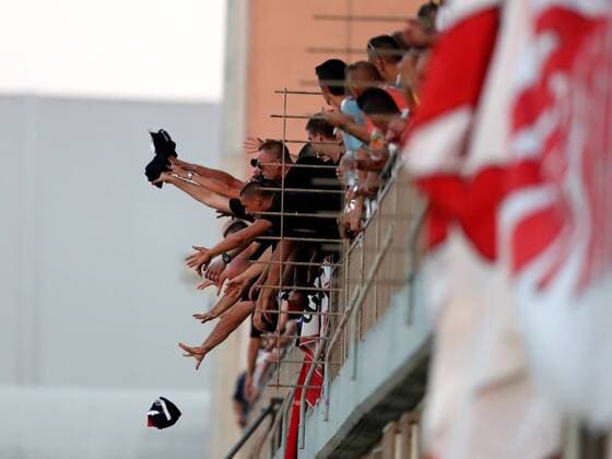 HÅ K Zrinjski supporters lunge forward to grasp the team jerseys thrown to them by their club players after their team won qualification to the next round of the UEFA Europa League, having beaten Valletta 2-1 in the second Qualifying Round, second leg match between the two teams at the Centenary Stadium, Ta Qali, Malta on 02 August, 2018. Valletta FC v HÅ K Zrinjski UEL_18_19