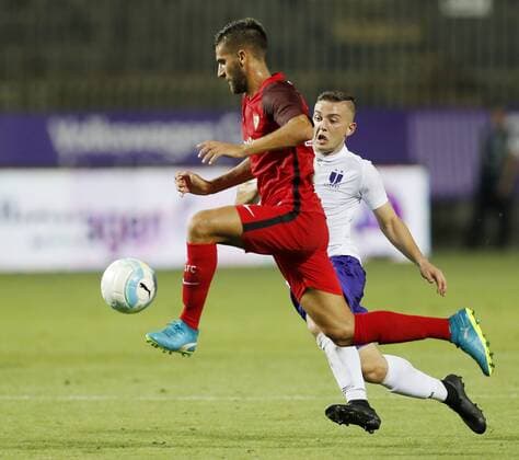 BUDAPEST, HUNGARY - AUGUST 2: (l-r) Pejino of Sevilla FC competes for the ball with Donat Zsoter of Ujpest FC during the UEFA Europa League Second Qualifying Round 2nd Leg match between Ujpest FC and Sevilla FC at Ferenc Szusza Stadium on August 2, 2018 in Budapest, Hungary. LaszloxSzirtesi 