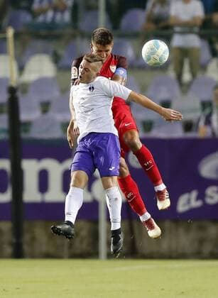 BUDAPEST, HUNGARY - AUGUST 2: (l-r) Donat Zsoter of Ujpest FC battles for the ball in the air with Daniel Carrico of Sevilla FC during the UEFA Europa League Second Qualifying Round 2nd Leg match between Ujpest FC and Sevilla FC at Ferenc Szusza Stadium on August 2, 2018 in Budapest, Hungary. LaszloxSzirtesi 