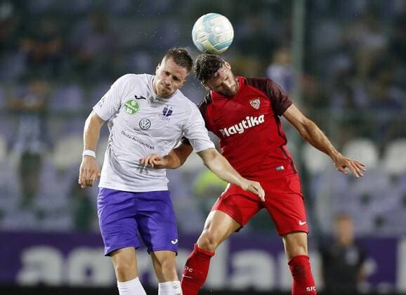 BUDAPEST, HUNGARY - AUGUST 2: (l-r) Soma Novothny of Ujpest FC battles for the ball in the air with Sergi Gomez of Sevilla FC during the UEFA Europa League Second Qualifying Round 2nd Leg match between Ujpest FC and Sevilla FC at Ferenc Szusza Stadium on August 2, 2018 in Budapest, Hungary. LaszloxSzirtesi 