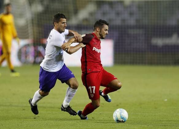 BUDAPEST, HUNGARY - AUGUST 2: (l-r) Bojan Sankovic of Ujpest FC competes for the ball with Pablo Sarabia of Sevilla FC during the UEFA Europa League Second Qualifying Round 2nd Leg match between Ujpest FC and Sevilla FC at Ferenc Szusza Stadium on August 2, 2018 in Budapest, Hungary. LaszloxSzirtesi 