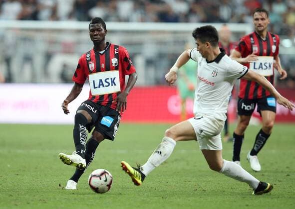 SOCCER - UEFA EL quali, Besiktas vs LASK ISTANBUL,TURKEY,09.AUG.18 - SOCCER - UEFA Europa League qualification, Besiktas Istanbul vs LASK Linz. Image shows Yussuf Otubanjo (LASK) and Necip Uysal (Besiktas). GEPAxpictures xHaraldxSteiner