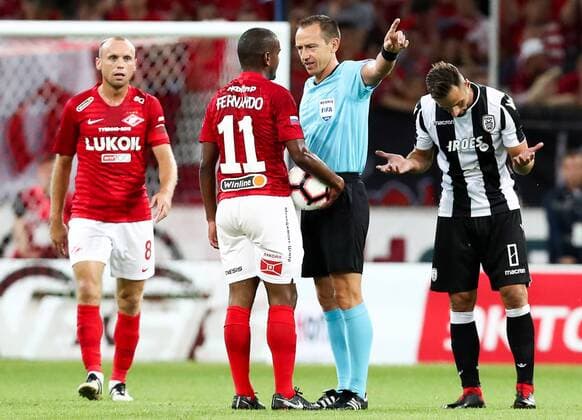 MOSCOW, RUSSIA - AUGUST 14, 2018: Spartak Moscowâ€™s Denis Glushakov, Lucas Fernando, referee Ruddy Buquet, and PAOK Thessalonikiâ€™s Jose Mauricio (L-R) in their 2018-19 UEFA Champions League third qualifying round match at Moscow s Otrkitie Arena. Stanislav Krasilnikov TASS  TS08CC0F