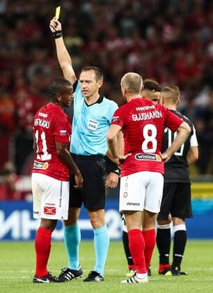 MOSCOW, RUSSIA - AUGUST 14, 2018: Referee Ruddy Buquet (C) shows the yellow card to Spartak Moscowâ€™s Lucas Fernando (L) in their 2018-19 UEFA Champions League third qualifying round match against PAOK Thessaloniki at Moscow s Otrkitie Arena. Stanislav Krasilnikov TASS  TS08CC22