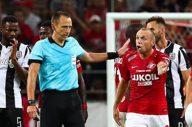 MOSCOW, RUSSIA - AUGUST 14, 2018: Referee Ruddy Buquet and Spartak Moscowâ€™s Denis Glushakov (L-R front) in their 2018-19 UEFA Champions League third qualifying round match against PAOK Thessaloniki at Moscow s Otkritie Arena. Anton Novoderezhkin TASS  TS08CC2D