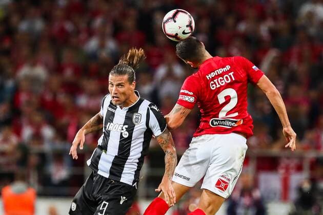 MOSCOW, RUSSIA - AUGUST 14, 2018: PAOK Thessaloniki s Aleksandar Prijovic (L) and Spartak Moscowâ€™s Samuel Gigot in their 2018-19 UEFA Champions League third qualifying round match at Moscow s Otkritie Arena; the teams drew 0-0. Anton Novoderezhkin TASS  TS08CC4D
