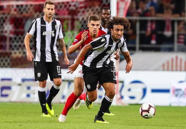 MOSCOW, RUSSIA - AUGUST 14, 2018: Spartak Moscowâ€™s Roman Zobnin (C), PAOK Thessalonikiâ€™s Amr Warda (L) and Jose Canas in their 2018-19 UEFA Champions League third qualifying round match at Moscow s Otkritie Arena; the teams drew 0-0. Anton Novoderezhkin TASS  TS08CC52