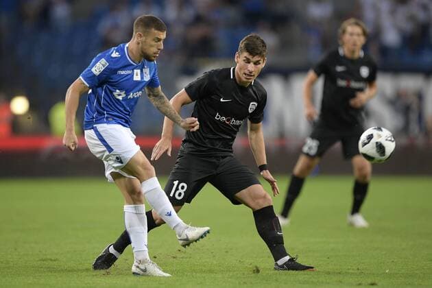 Poznan s Pedro Tiba and Genk s Ruslan Malinovski fight for the ball during a soccer game between Polish club Lech Poznan and Belgian team KRC Genk, Thursday 16 August 2018 in Poznan, Poland, the return leg of the third qualification round for the Europa League competition. YORICKxJANSENS  x05407006x