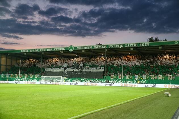 Monday 20 08 2018 Season 2018 19 DFB Pokal 1 main round at Ronhof Sports Park SpVgg Greuther Fürth BVB 09 Borussia Dortmund The Fürth fans support their team in the home curve choreography on the occasion of the 105th anniversary of SpVgg Fürth with green and white foil flags and a block banner from the Wilhelminian period