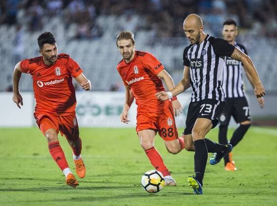 23rd August 2018, Partizan Stadium, Belgrade, Serbia; UEFA Europa League qualification 1st leg, Partizan versus Besiktas; Nemanja Miletic of Partizan passes the ball as Caner Erkin and Tolgay Arslan of Besiktas try to stop his run  ActionPlus12057553 NikolaxKrstic