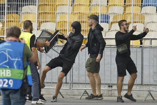 August 28, 2018 - Kiev, Ukraine - Stewards try to stop a local soccer hooligan from throwing a chair at Ajax fans before the UEFA Champions League play-off, second leg, soccer match between FC Dynamo Kyiv and Ajax Amsterdam, at the Olimpiyskiy stadium in Kiev, Ukraine, on 28 August 2018. Ajax Amsterdam vs FC Dynamo Kiev , UEFA Champions League soccer match - ZUMAg194 20180828_zap_g194_028 Copyright: xSergxGlovnyx