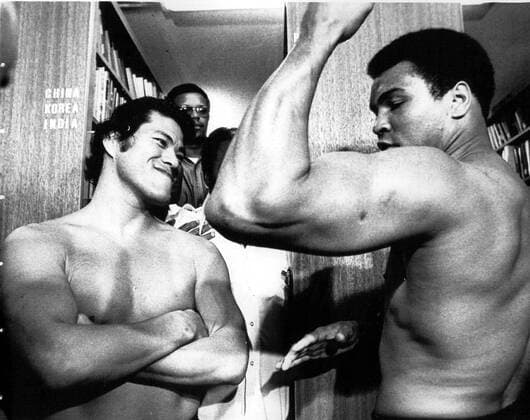 WORLD HEAVYWEIGHT CHAMPION MUHAMMAD ALI SH OWS OFF HIS BICEPS TO JAPANESE WRESTLING CHAMPION ANTONIO INOKI 18 06 PRIOR TO WEIGH-IN FOR THEIR SCHEDULED BOXING-WRESTLING MATCH HERE 26 06.. .JEP WST BELGA  x85196517stx