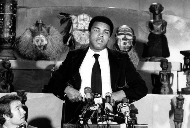 THERE S NO NEED FER INTRODUCTION HERE BUT MR. YOU KNOW WHO IS DOING WHAT COMES NATURALLY APART FROM BOXING ,OF COURSE. MUHAMMAD ALI WAS IN FULL VOCAL FERM AT A press conference PK Pressekonferenz HELD HERE JUST RECENTLY. MONOPOLISING THE MICROPHONES,AS USUAL, ALI CHIDED UNDEFEATED WORLD CHAMPION GEORGE FOREMAN FOR NOT APPEARING . THE TWO WILL COLLECT 5 MILLION FOR THE TITLE BOUT THAT WILL TAKE PLACE KINSHASA,ZAIRE ON SEPTEMBER 25TH. .HPT WST BELGA  x85197286stx