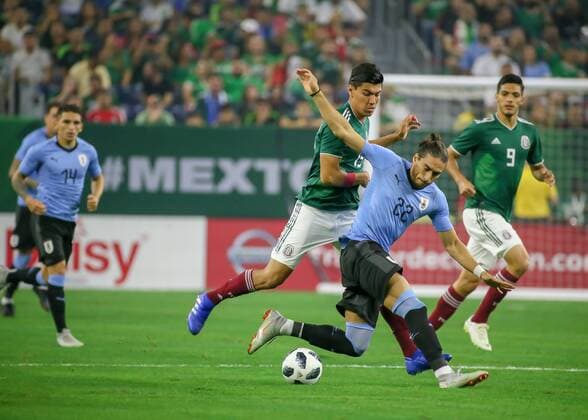 HOUSTON, TX - SEPTEMBER 07: Mexico midfielder Erick Gutierrez (15) and Uruguay defender Martin Caceres (22) fight for ball during the soccer match between Mexico and Uruguay on September 7, 2018 at NRG Stadium in Houston, Texas. (Photo by Leslie Plaza Johnson Icon Sportswire) SOCCER: SEP 07 Mexico v Uruguay Icon180907008 EDITORIAL USE ONLY