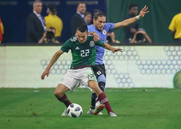 HOUSTON, TX - SEPTEMBER 07: Mexico forward Hirving Lozano (22) keeps the ball away from Uruguay defender Martin Caceres (22) during the soccer match between Mexico and Uruguay on September 7, 2018 at NRG Stadium in Houston, Texas. (Photo by Leslie Plaza Johnson Icon Sportswire) SOCCER: SEP 07 Mexico v Uruguay Icon180907022 EDITORIAL USE ONLY