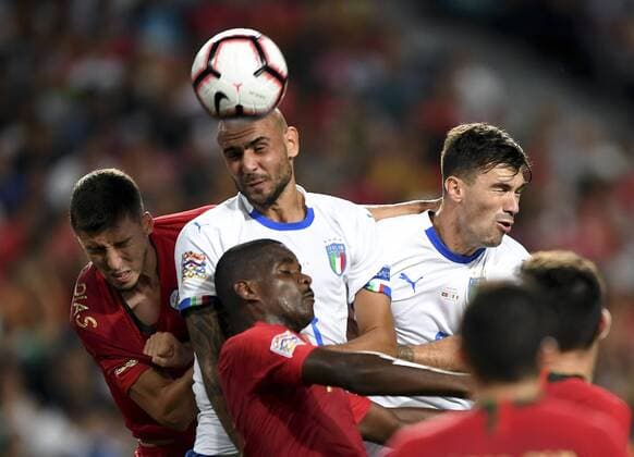 (180911) -- LISBON, Sept.11, 2018 -- Ruben Dias (1st L) of Portugal heads the ball with Simone Zaza (2nd L) of Italy during the UEFA Nations League soccer match between Portugal and Italy at Luz Stadium in Lisbon, Portugal, on Sept. 10, 2018. Portugal won 1-0. )(wll) (SP)PORTUGAL-LISBON-SOCCER-UEFA-NATIONS LEAGUE-PORTUGAL VS ITALY ZhangxLiyun 