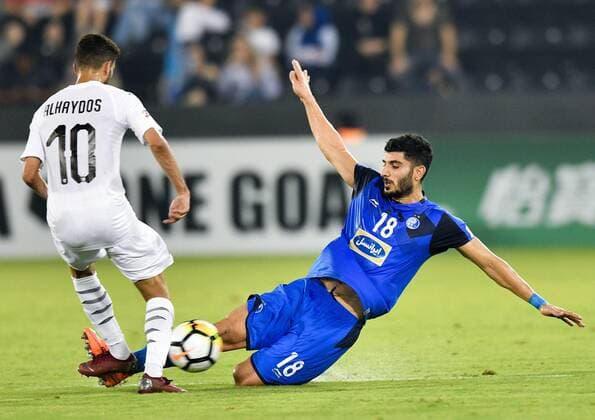 (180918) -- DOHA, Sept. 18, 2018 -- Hasan Al Haydos (L) of Al Sadd vies with Milad Zakipour of Esteghlal FC during the AFC Asian Champions League quarterfinal second leg football match between Qatar s Al Sadd and Iran s Esteghlal FC in Doha, capital of Qatar, Sept. 17, 2018. Al Sadd was qualified for the semifinal after a 2-2 draw in the second leg of the quarterfinal with Esteghlal FC gave them a 5-3 aggregate win. ) (SP)QATAR-DOHA-FOOTBALL-AFC-ASIAN CHAMPIONS LEAGUE Nikku 