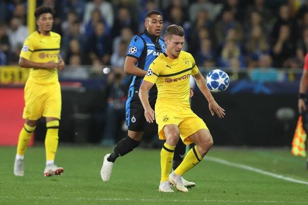 Club s Arnaud Danjuma and Dortmund s Lukasz Piszczek fight for the ball during a game between Belgian soccer team Club Brugge KV and German club Borussia Dortmund, in Brugge, Tuesday 18 September 2018, day one of the UEFA Champions League, in group A. BRUNOxFAHY  x05428696x