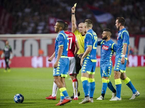 FuÃŸball, CL, Roter Stern Belgrad - SSC Neapel 18th September 2018, Rajko Mitic Stadium, Belgrade, Serbia; UEFA Champions League football, Red Star Belgrade versus Napoli; Referee Szymon Marciniak of Poland gives a yellow card to Nenad Krsticic of Red Star Belgrade  ActionPlus12063608 NikolaxKrstic