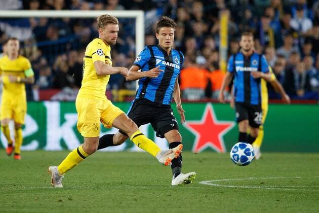 Dortmund s Marcel Schmelzer and Club s Jelle Vossen fight for the ball during a game between Belgian soccer team Club Brugge KV and German club Borussia Dortmund, in Brugge, Tuesday 18 September 2018, day one of the UEFA Champions League, in group A. KURTxDESPLENTER  x05428772x