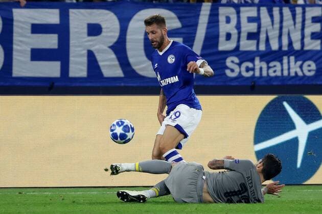 (180919) -- GELSENKIRCHEN, Sept. 19, 2018 -- Guido Burgstaller (L) of Schalke 04 vies with Alex Telles of Porto during the UEFA Champions League football match between Schalke 04 and FC Porto at the Veltins Arena on Sept. 18, 2018 in Gelsenkirchen, Germany. The match ended 1-1. ) (SP)GERMANY-GELSENKIRCHEN-FOOTBALL-UEFA CHAMPIONS LEAGUE JoachimxBywaletz 