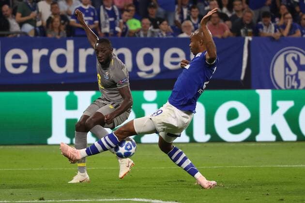 (180919) -- GELSENKIRCHEN, Sept. 19, 2018 -- Naldo (R) of Schalke 04 and Marega of Porto fight for the ball during the UEFA Champions League football match between Schalke 04 and FC Porto at the Veltins Arena on Sept. 18, 2018 in Gelsenkirchen, Germany. The match ended 1-1. ) (SP)GERMANY-GELSENKIRCHEN-FOOTBALL-UEFA CHAMPIONS LEAGUE JoachimxBywaletz 