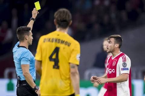 AMSTERDAM, AFC Ajax - AEK Athens FC, football, Champions League, season 2018-2019, 19-09-2018, Stadium Johan Cruijff Arena, referee Carlos Del Cerro (L) gives a yellow card to Ajax player Nico Tagliafico (R) Ajax - AEK Athens  x2477126x