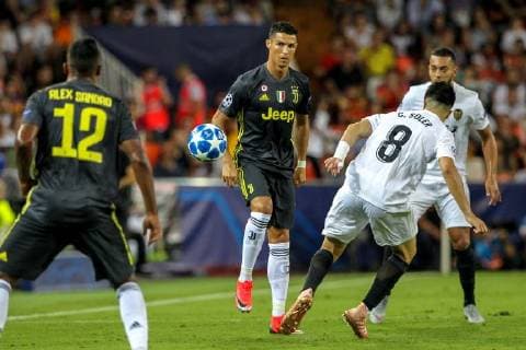 19th September 2018, Mestalla, Valencia, Spain; UEFA Champions League football, Valencia versus Juventus; Cristiano Ronaldo of Juventus Turin passes the ball back to Sandro as Solder closes him down  ActionPlus12063827 PedroxSalado
