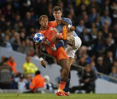 Manchester City defender John Stones challenges Lyon forward Memphis Depay during the UEFA Champions League Group F match at the Etihad Stadium, Manchester. Picture date 19th September 2018. Picture credit should read: Andrew Yates Sportimage EDITORIAL USE ONLY. No use with unauthorised audio, video, data, fixture lists, club league logos or live services. Online in-match use limited to 120 images, no video emulation. No use in betting, games or single club league player publications.