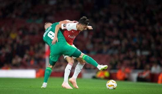 Mesut ?zil of Arsenal battles Mykhaylo Serhiychuk of Vorskla Poltava during the UEFA Europa League match group between Arsenal and Vorskla Poltava at the Emirates Stadium, London, England on 20 September 2018. Copyright: xAAx PMI-2243-0065