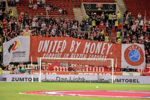 Transparent banner of the fans in the VfB fan block with the text United by Money Corrupt in the heart of Europe Germany Stuttgart 21 09 2018 Sport Football Bundesliga VfB Stuttgart vs Fortuna Duesseldorf Mercedes Benz Arena DFL DFB REGULATIONS PROHIBIT ANY USE OF PHOTOGRAPH AS IMAGE SEQUENCES AND OR QUASI VIDEO