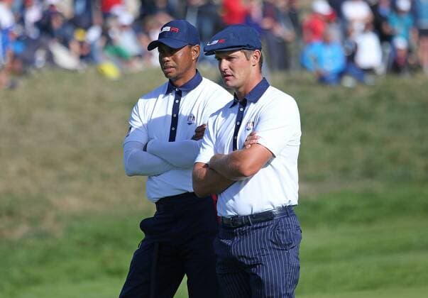 Tiger Woods (L) and Bryson DeChambeau watch Tommy Fleetwood putt on the 9th green on day two of the Ryder Cup at Le Golf National in Guyancourt near Paris on September 29, 2018. Fleetwood and teammate Francesco Molinari won the 9th hole on Fleetwood s putt..  PAR20180929029 DAVIDxSILPA