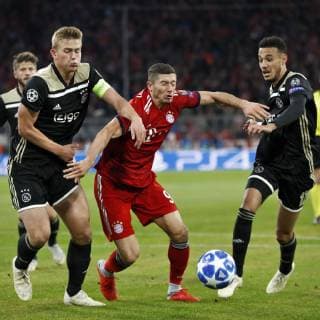MUNCHEN, 02-10-2018, Allianz Arena, season 2018 2019, Champions League football. Bayern Munchen player Robert Lewandowski (C) and Ajax midfielder Noussair Mazraoui (R) and Ajax defender Matthijs de Ligt (L) during the Bayern Munchen - Ajax (L) . Bayern Munchen - Ajax  x2515650x